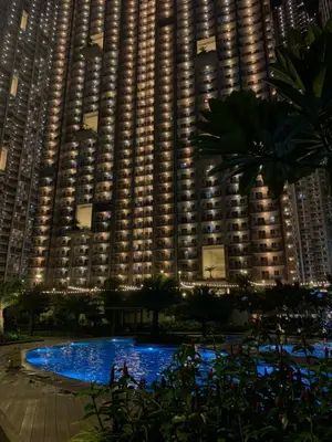 a large building with a pool in front of it at 2BR 38th flr SIESTA SPACE in PRISMA Residences in Manila