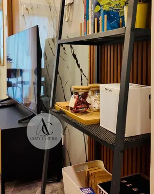 a shelf with a monitor and a computer on it at Cozy staycation 1BR with WiFi, Netflix and more at Shore 3 MOA by Angels Cozy Corner in Manila