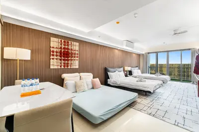 a living room with a bed and a table at Elegant Studio City View near Airport, City of Dreams, Okada, Solaire, PARQAL, Ayala Malls, and MOA in Manila