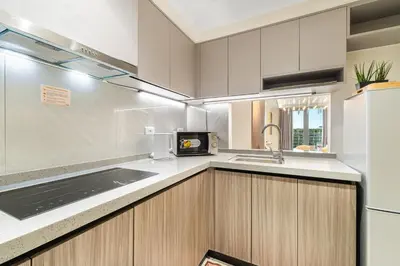 a kitchen with a sink and a microwave at Elegant 2BR City View near City of Dreams, Okada, Solaire, PARQAL, Ayala Malls, MOA, and Airport in Manila