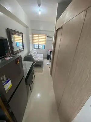 a living room with a couch and a table at 2 bedroom condo at Leaf Residences Muntinlupa in Manila