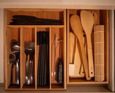 a wooden cabinet with utensils in it at Wabi-Sabi Stay at Knightsbridge Residences in Manila