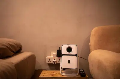 a cell phone sitting on a table next to a couch at Wabi-Sabi Stay at Knightsbridge Residences in Manila