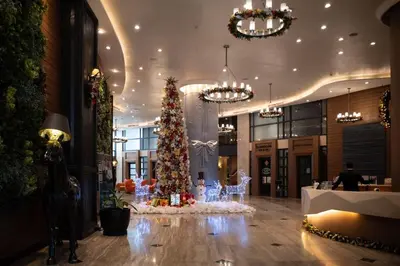 a christmas tree in the middle of a lobby at Wabi-Sabi Stay at Knightsbridge Residences in Manila