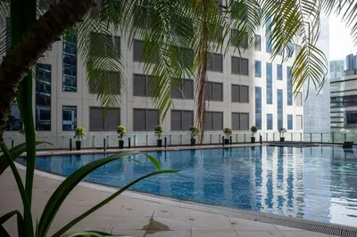 a large swimming pool in front of a building at Wabi-Sabi Stay at Knightsbridge Residences in Manila