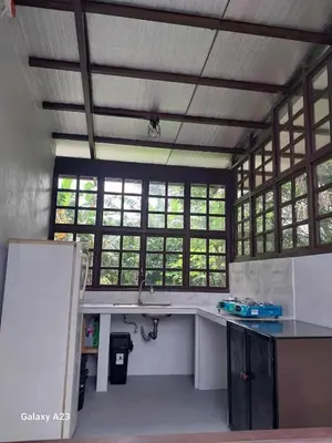 a kitchen with a sink and some windows at Sehaliah Agricultural Farm Resort in Amadeo