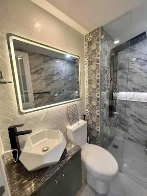 a bathroom with a toilet and a sink and a shower at Guest House Ground Zero in Manila