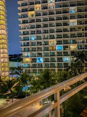 a view of a large building at night at Premiere Staycation in Manila