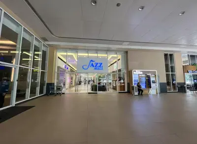 an empty mall with an akita sign in a building at Jazz Residences Condo in Manila