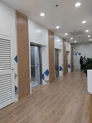 a hallway with blue arrows painted on the walls of a building at Condotels by Versola in Manila