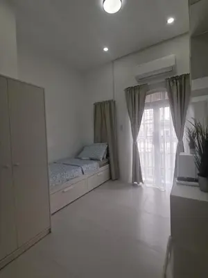 a bedroom with a bed and a large window at Ikea inspired home with mini balcony and free parking in Cainta