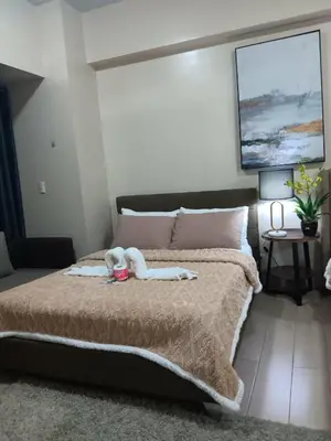 a bedroom with a bed with a stuffed animal on it at Spacious Studio 3B C5 in Manila