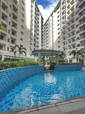 a large swimming pool in front of some buildings at Casa Kanlungan at Spring Residences Tower 3 in Manila