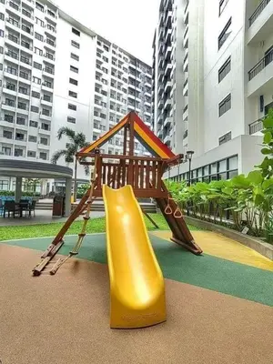 a playground with a slide in a city at Casa Kanlungan at Spring Residences Tower 3 in Manila