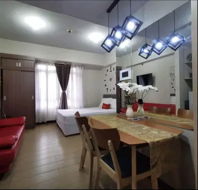 a room with a dining table and a bedroom at NAIA TERMINAL 3 Condo Rentals in Manila
