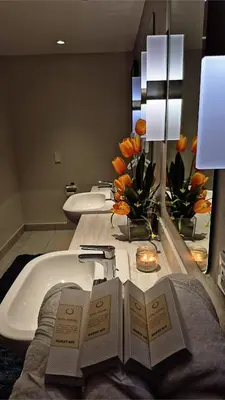 a bathroom with a bath tub with two books on it at Luxe 1BR Panorama Suite at Novotel Aqua in Manila