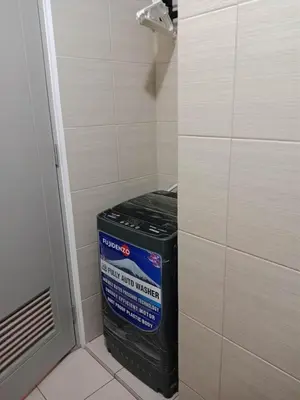 a trash can in a corner of a bathroom at Raku Home - Urban Resort Living in Manila