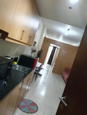 a kitchen with a sink and a counter top at Sea Residences peya in Manila