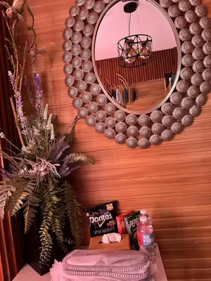 a mirror on a wall with a table with a cake at Modern 1BR Condo in Pasay With Balcony City View Free Swimming Pool Near NAIA Airport, PICC, CCP, MOA in Manila