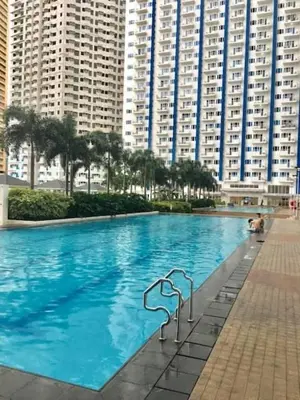 a large swimming pool in front of tall buildings at Light Residences by SMDC Boni MRT EDSA in Manila