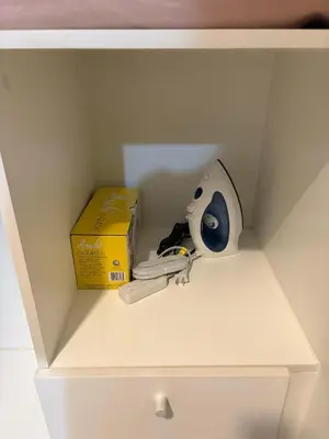 a white drawer with a box and a mask and a router at Luxury-Styled 2BR Uptown T2 Parksuites BGC in Manila