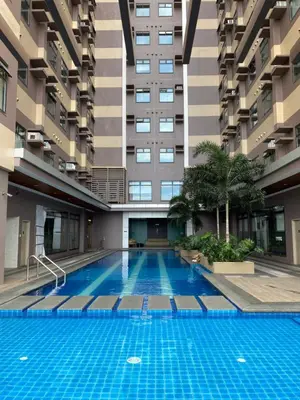 a swimming pool in the middle of a building at Sofi Staycation- Aurora Escalades in Manila