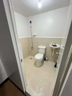 a bathroom with a toilet and a sink at Jade Condo Netflix Wifi Karaoke with Cinema Projector in Imus