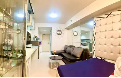 a living room with a couch and a table at RoseCondoHotel in Manila