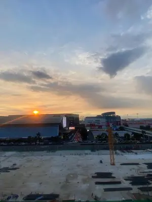 a view of a city with the sunset in the background at RoseCondoHotel in Manila