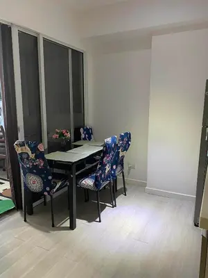 a dining room with a black table and chairs at AFFORDABLE STAYCATION NEAR Airport in Manila