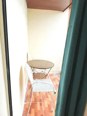 a glass table and a chair in a room at mooring in Manila