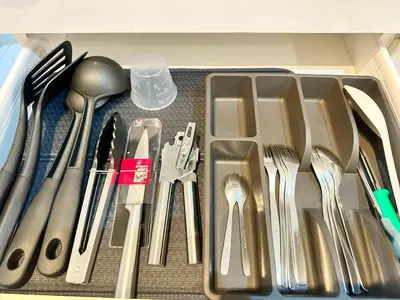 a drawer filled with silver utensils in a drawer at 1BR Condotel in Azure Urban Resort near NAIA #TRO4 in Manila