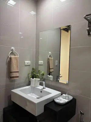 a bathroom with a white sink and a mirror at Venice Luxury Residences Emanuele in Manila