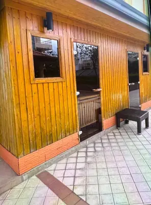 a wooden building with a bench in front of it at Venice Luxury Residences Emanuele in Manila