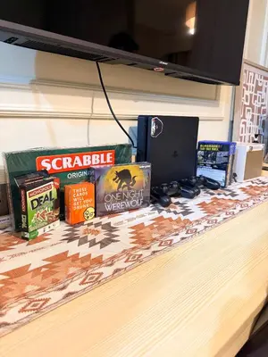 a counter with books and a laptop on it at Relaxing 1BR Condo near MOA & NAIA with WiFi, PS4, Karaoke in Manila