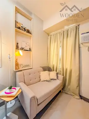 a living room with a couch and a table at Wooden White in Manila