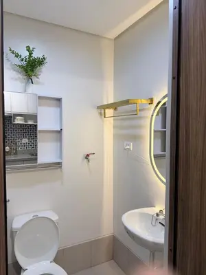 a bathroom with a toilet and a sink at 2 BR Modern Apartment Near the Airport in Manila
