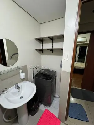a bathroom with a sink and a mirror at Next Abode 1BR at TheBeaconMakati in Manila