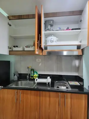 a kitchen with a sink and a counter top at The Nook at the Shore in Manila