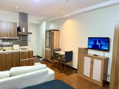 a room with a kitchen and a living room at The Gramercy Residences in Manila