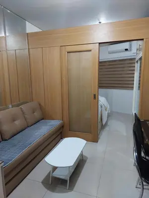 a small room with a couch and a table at She'll residences condotel in Manila