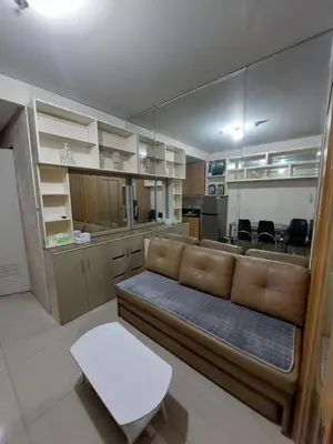 a living room with a couch and a kitchen at She'll residences condotel in Manila