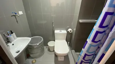 a small bathroom with a toilet and a sink at Cozy & Affordable Stay in Air Residences in Manila