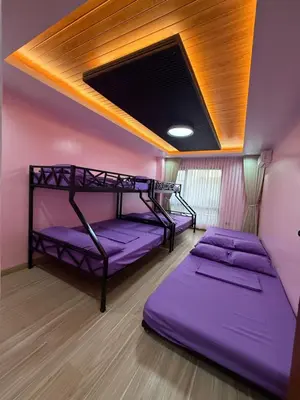 two bunk beds in a room with purple walls at Bella Tamara Private Resort in Binangonan