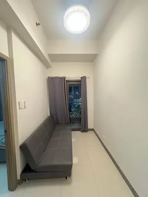 a empty room with a couch in a room at Seva Condo Residences in Manila