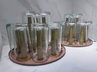 a row of glass jars filled with green liquid at Hidden Leaf Private Resort in Dasmariñas