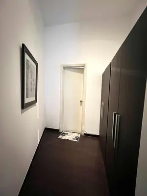 a room with a hallway with a door and a magazine at The Gramercy Residences by YYESS in Manila