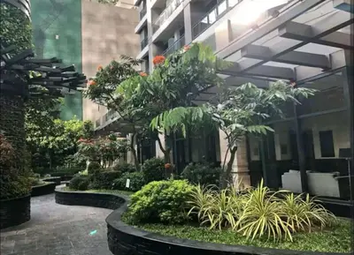 a courtyard of a building with plants and trees at The Gramercy Residences by YYESS in Manila