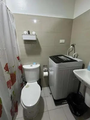 a bathroom with a toilet and a sink at ALFA staycation at Shore 2 tower 1 Pasay City in Manila