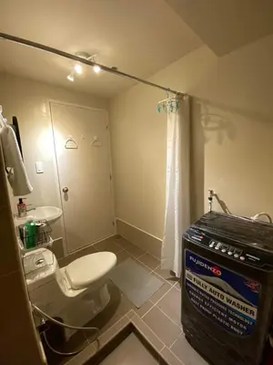 a bathroom with a toilet and a box in it at Vacation at Tolentino Residence in Manila